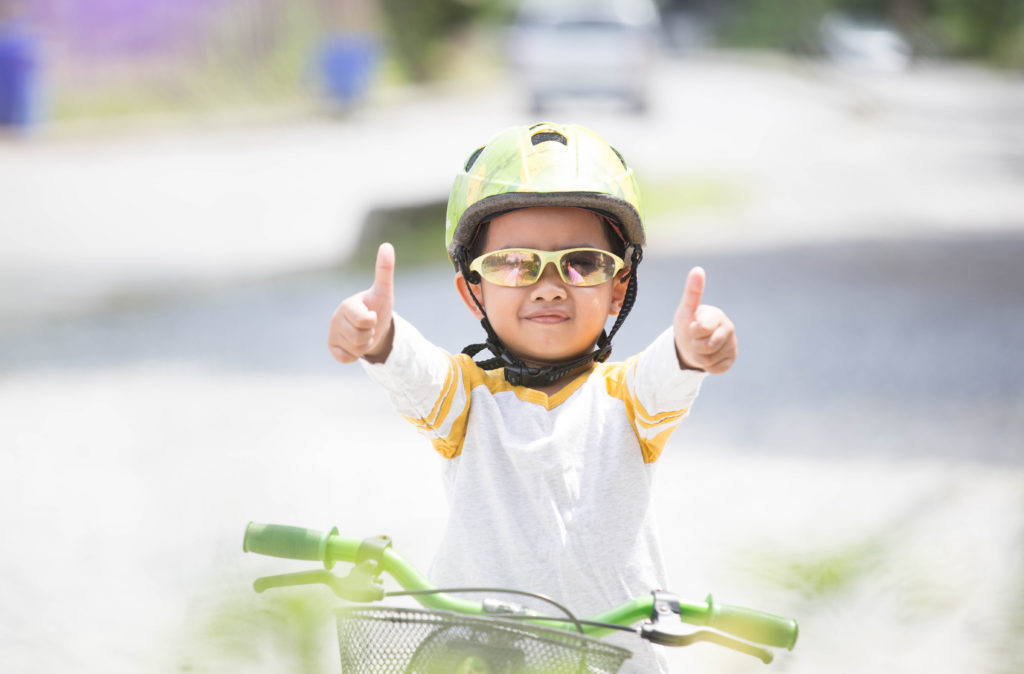 boy on bike giving thumbs up